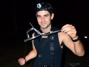 Elliot from the UK with a wolf snake while herping Krabi, Thailand with us for a long reptile internship in 2013.