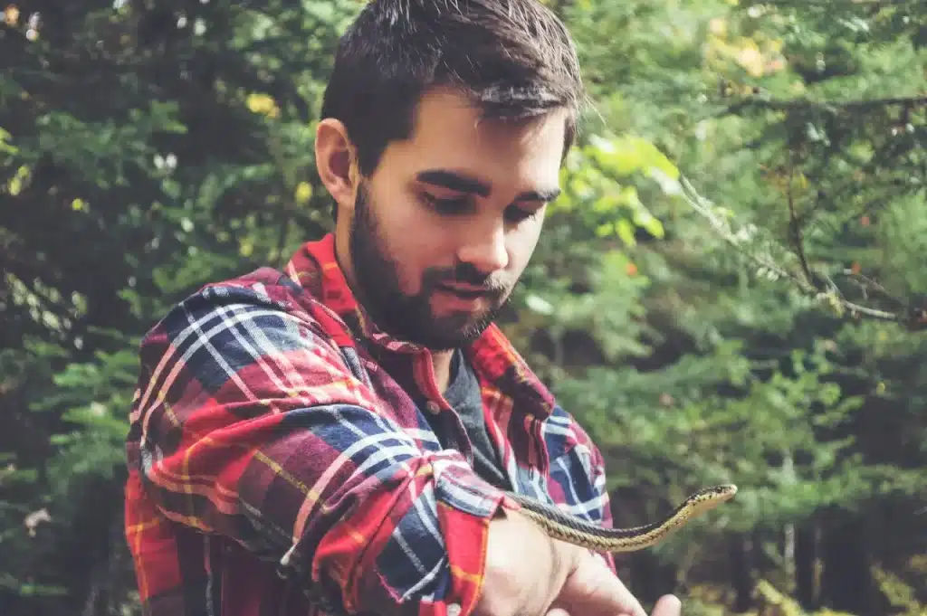 Man Holding A Snake Herpetologists & Snake Enthusiasts